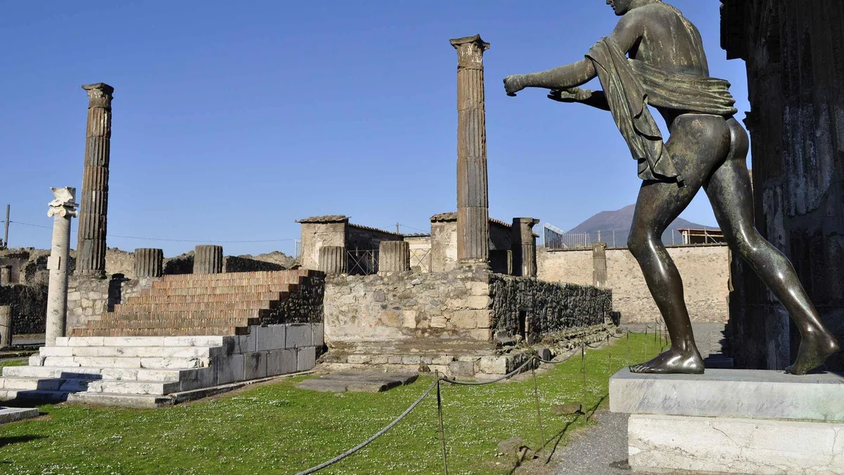 Roman columns and paving in the ruins of Pompeii on a clear morning, the site visited on the skip-the-line Pompeii ruins all-inclusive tour from Sorrento, Campania, Italy